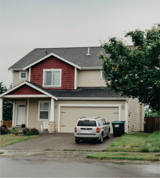 Exterior shot of a house with a car parked in the driveway