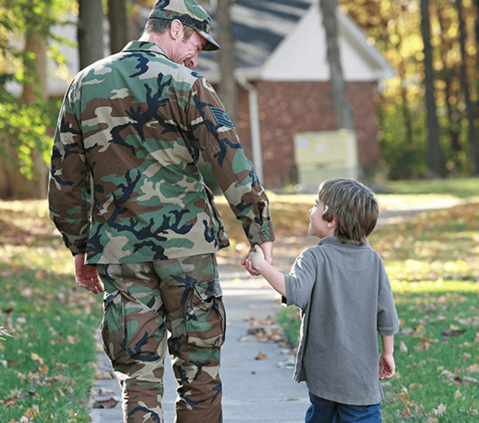father holding sons hand